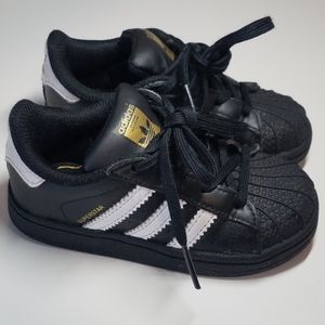 Black, white and gold adidas superstar